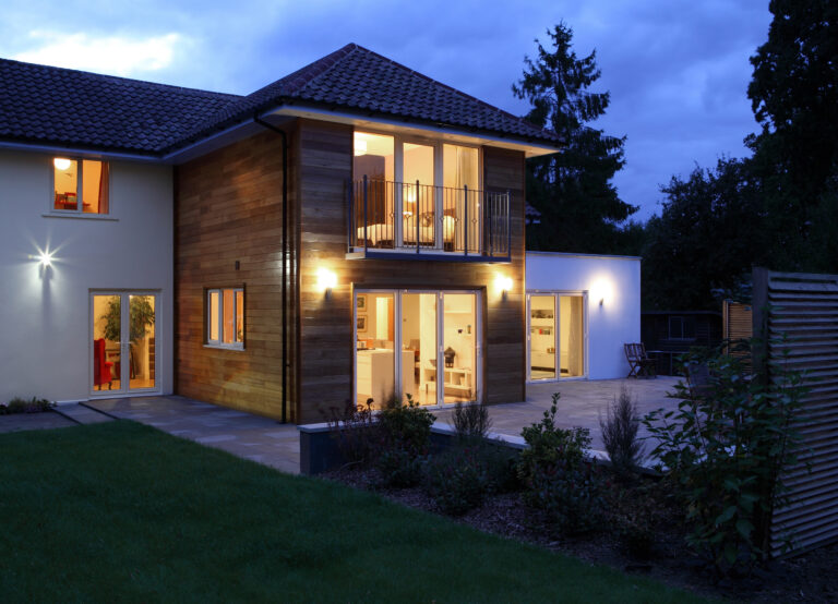 lights operating in large house at night, photo taken from outside