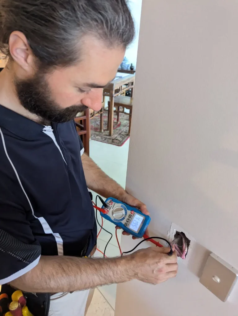 Intelligent Automation Electrician measuring current in amps on multimeter of faulty C-Bus Switch